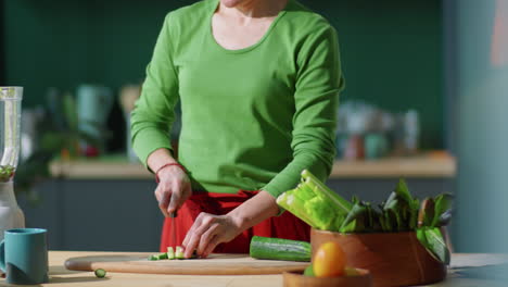 Woman-Cutting-Cucumber-and-Putting-It-into-Blender-at-Home